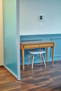 a wooden desk with a stool next to it at Telegraph in Kamakura