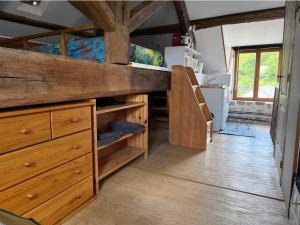 a room with a bunk bed and wooden cabinets at Studio in Bruyères-le-Châtel