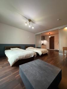 a bedroom with two beds and a table at Telegraph in Kamakura