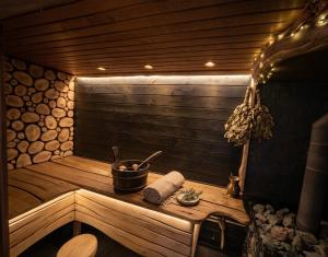 a wooden sauna with a wooden table in a room at At the old blacksmith in Daugavpils