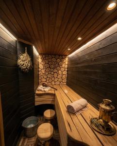 a wooden sauna with two stools and a tub at At the old blacksmith in Daugavpils