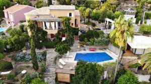 an aerial view of a house with a swimming pool at Villa Les Dauphins in Le Lavandou