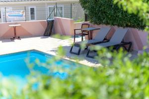 two chairs and a table next to a swimming pool at Camping 2 étoiles - Piscine - ccbgb0d in Sospel