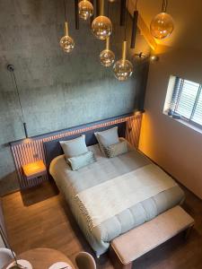 a large bed in a room with lights at La Gazolina in Boeseghem