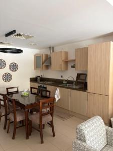 a kitchen and dining room with a table and chairs at Samara in Sowayma