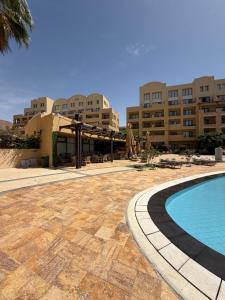 a resort with a swimming pool and some buildings at Samara in Sowayma