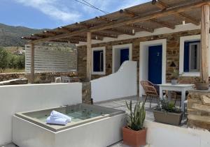 a hot tub on the patio of a house at Aloni Ios in Mylopotas