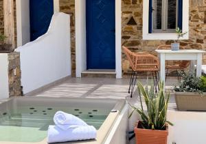 a hot tub on the patio of a house at Aloni Ios in Mylopotas