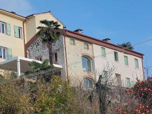 a building with a palm tree on top of it at Fairytale old stonehouse in Brendola