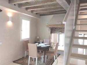 a dining room with a black table and chairs at Fairytale old stonehouse in Brendola +23 photos