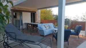 a patio with chairs and a table and a table and chairs at Fairytale old stonehouse in Brendola