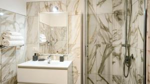 a bathroom with a sink and a shower at Castelsardo Appartment in Castelsardo +8 photos