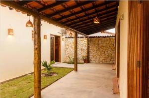 a hallway of a house with a stone wall at Casa Revoada BG PI in Barra Grande