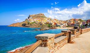 a view of a town on a hill next to the ocean at Castelsardo Appartment in Castelsardo