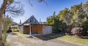 a small house with a shed in a yard at Adventure Base in Ohakune +7 photos