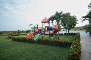 a playground with a slide in a park at Hotel Arbóreo Doradal in Doradal