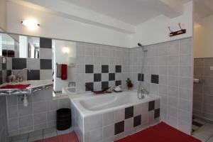 a bathroom with a large white tub and a sink at le clos saint François in Beaune-sur-Arzon