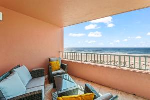 a balcony with a view of the ocean at Beachfront Waves in Bradenton Beach