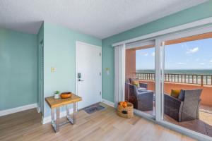 a living room with a view of the ocean at Beachfront Waves in Bradenton Beach +27 photos
