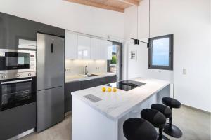 a kitchen with a white counter top and appliances at Villa Cypressa by Villa Plus in Kalamitsi