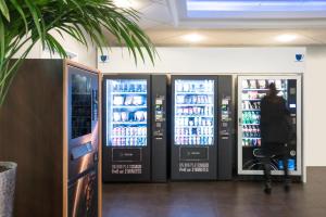 two vending machines in a store with drinks in them at ibis budget Paris Porte De Montmartre in Paris