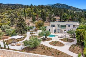 an aerial view of a house with a pool and trees at Villa Cypressa by Villa Plus in Kalamitsi