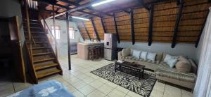 a living room with a couch and a table at Eagles Nest in Rustenburg