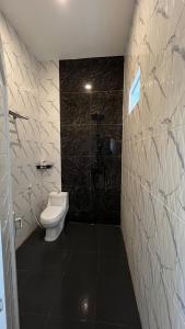 a bathroom with a toilet and a shower at Villa Adela Sky Land Malang in Karangploso +23 photos