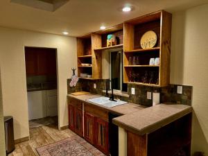 a kitchen with a sink and a counter top at The Bubbling Wells Oasis, 3 Homes on 107 Acres in Desert Hot Springs +70 photos