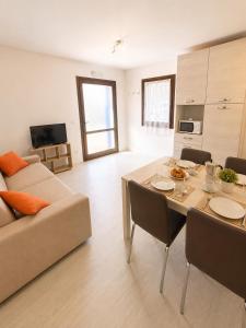 a living room with a table and a couch at Casa del Marinaio - Agenzia Cocal in Caorle