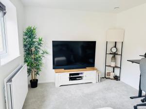 a flat screen tv sitting on a white entertainment center at Ansari Palace in Worting