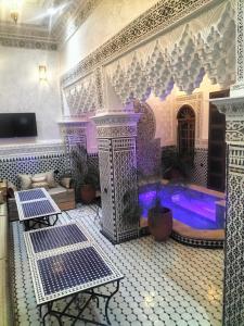 a large room with a pool in a building at Riad Diamant Bleu in Fez