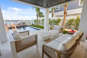 a patio with a view of the water and a pool at Big Nauti in Bradenton Beach