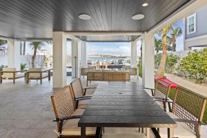 an outdoor patio with a wooden table and chairs at Big Nauti in Bradenton Beach +56 photos