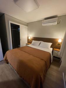 a bedroom with a large bed with white pillows at Rancho Dreamland in Gaspar