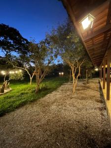a walkway leading to a yard at night at Rancho Dreamland in Gaspar