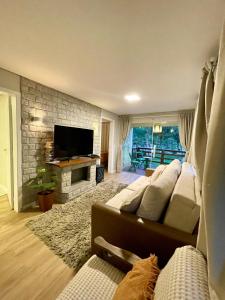 a living room with a couch and a television at Rancho Dreamland in Gaspar