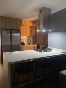 a kitchen with a white counter top and a refrigerator at Casa ORO VERDE in San Luis +26 photos