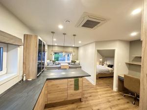 a kitchen and living room with a bed and a couch at Opulence Suite-Luxury New Build with Riverview in Montague