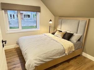 a bedroom with a large bed with a window at Opulence Suite-Luxury New Build with Riverview in Montague