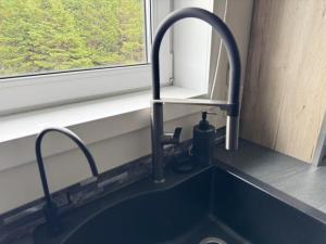 a kitchen sink with a faucet next to a window at Opulence Suite-Luxury New Build with Riverview in Montague +15 photos