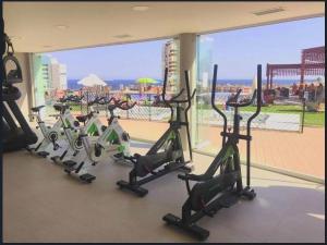 a row of treadmills in a gym with a view at Benidorm Luxury Residential in Benidorm