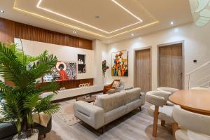 a living room with a couch and a table at Luxe Haven in Lekki