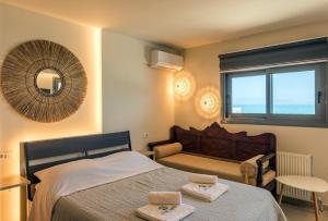 a bedroom with a bed with two towels on it at Sea Salt Studios in Nerántza