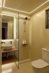 a bathroom with a toilet and a sink and a shower at Sea Salt Studios in Nerántza +18 photos