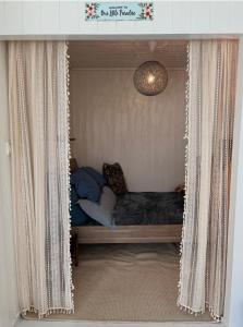 a bedroom with a bed in a curtain frame at Small Cozy apartment with Wi-Fi in Tjørhom