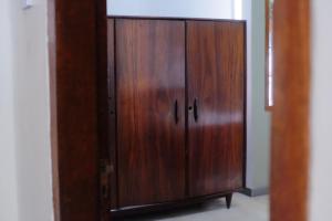 a wooden cabinet in a room next to a door at Atlasio House in Kasri