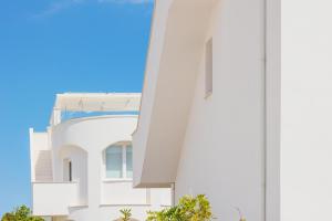 a white building with a blue sky in the background at Conero View in Marcelli