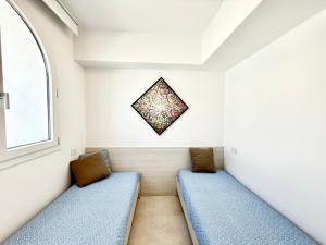 two blue benches in a room with a window at Conero View in Marcelli +9 photos