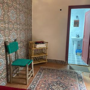 a bathroom with a chair and a sink in a room at Riad La Mentha Panoramic Terrace in Fes Medina in Fez +74 photos